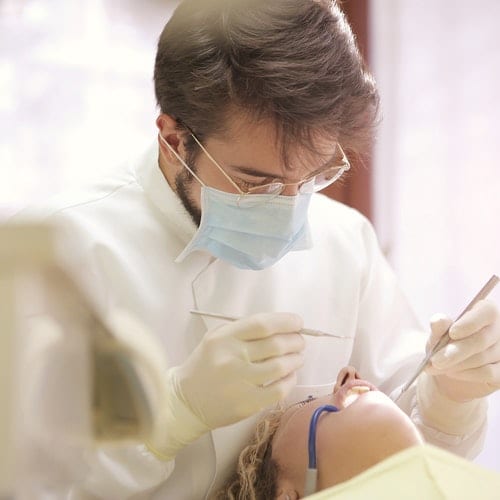 Dentist checking patient teeth
