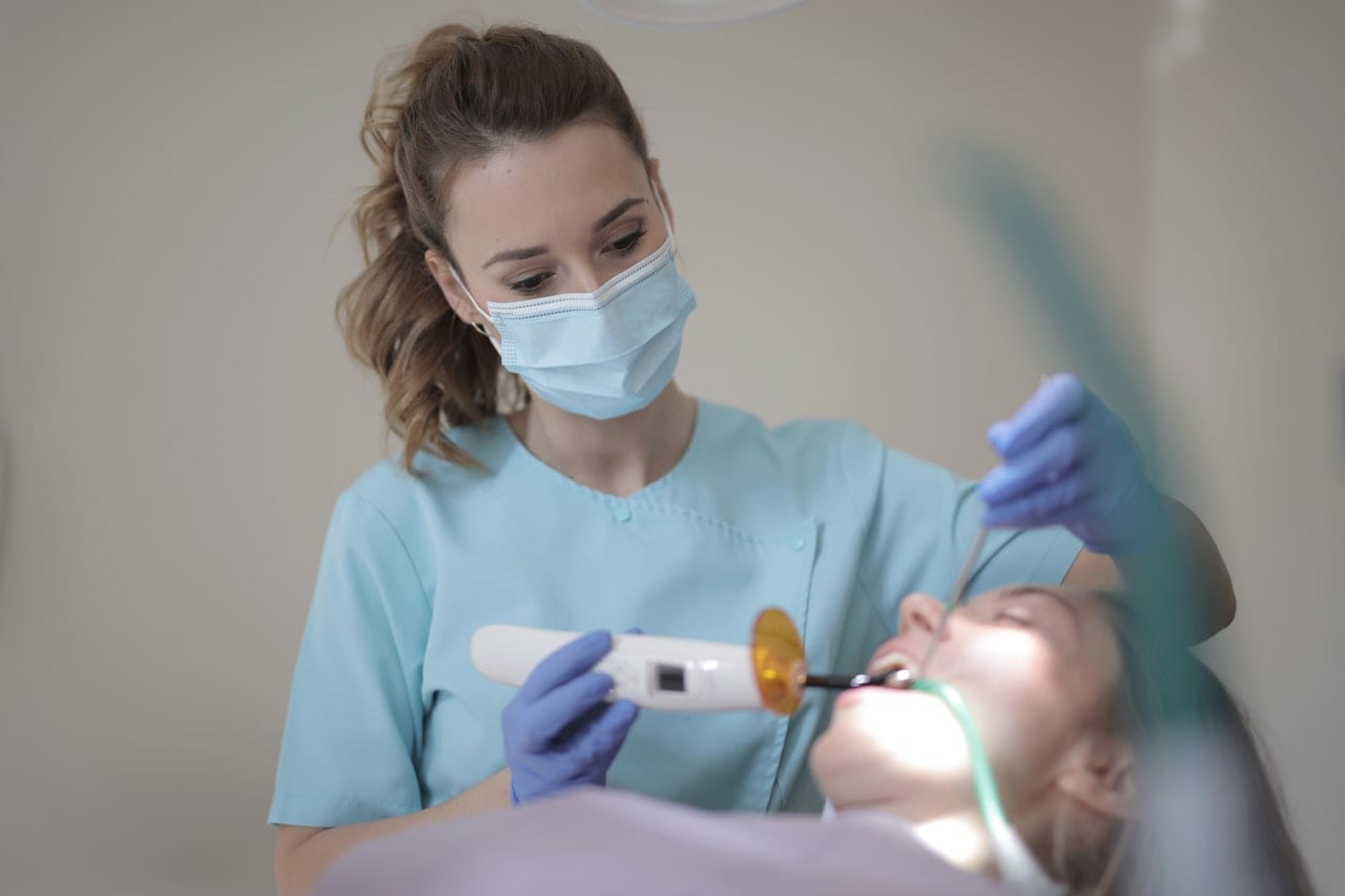 Dentist treating a patient with equipment